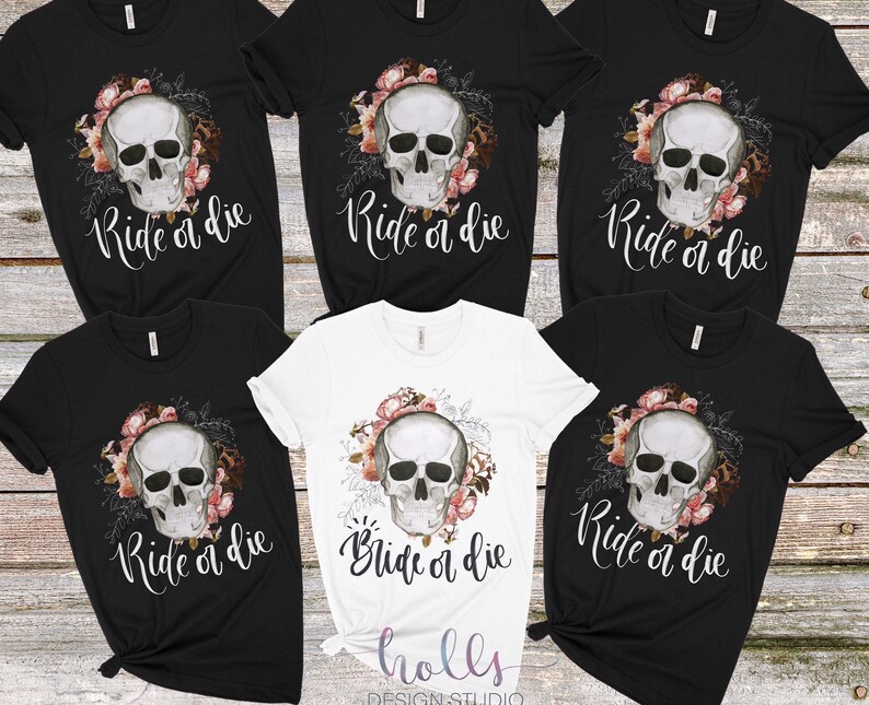 May include: Six black and white t-shirts with a floral skull graphic and the text "Ride or die" printed on the front.