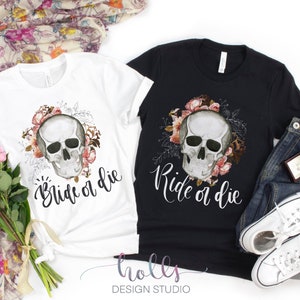 May include: Two black and white t-shirts with a skull and floral design. The white shirt says "Bride or Die" and the black shirt says "Ride or Die".