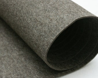 May include: A roll of gray felt fabric. The fabric is rolled up and the end of the roll is visible.