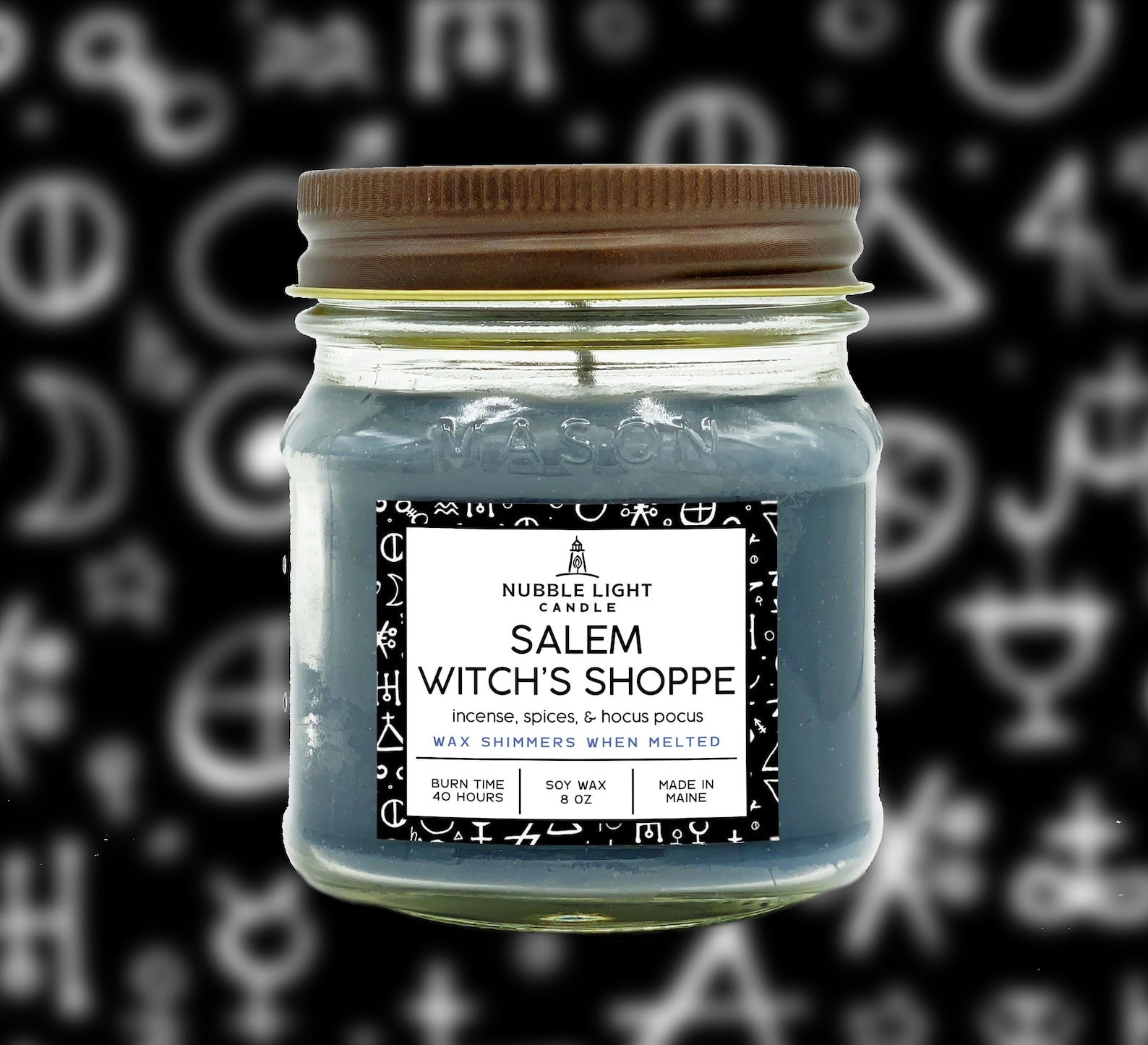 A teal soy candle in a glass jar with a white label that says 'Salem Witch's Shoppe' in black text.