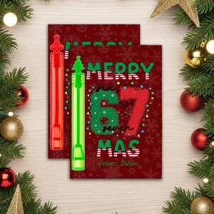 May include: A Christmas card with the text "Merry Six Seven Mas" in green and red, with a red background and snowflakes. Two bubble wands, one red and one green, are on the left. The card says "From: Dillon".