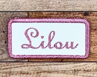 First name of your choice embroidered on a small rounded rectangle patch, metallic color of your choice, font of your choice, iron-on option