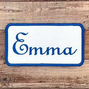 Embroidered name on a rounded rectangular patch. Silky thread, with or without iron-on backing.