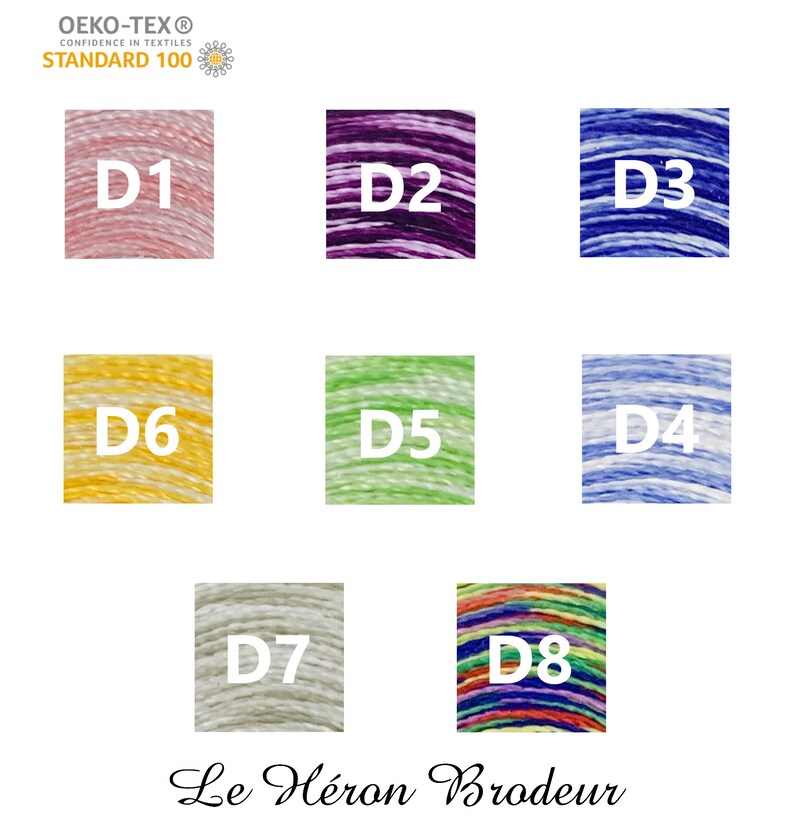 May include: Eight spools of embroidery floss in different colours, including pink, purple, blue, yellow, green, light blue, grey, and rainbow. The spools are labelled with the letters D1 through D8. The text "OEKO-TEX&reg; CONFIDENCE IN TEXTILES STANDARD 100" and "Le H&eacute;ron Brodeur" are also visible.