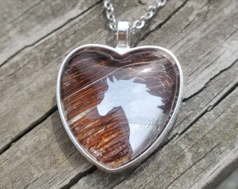 Heart shaped horse hair necklace by Equine Keepsakes with horse head emblem