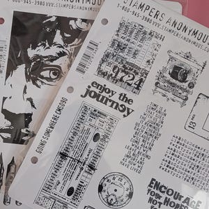 May include: Two sheets of Stampers Anonymous CMS090 stamps. One sheet features a black and white image of a face. The other sheet has various black stamps with text like "enjoy the journey" and "encourage your hopes not your fears".