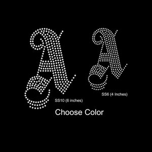 May include: Two rhinestone iron-on designs of the letter "A" in a cursive font. The larger design is 6 inches and the smaller design is 4 inches. Choose Color.