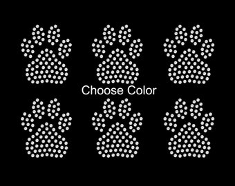 May include: Six white paw print designs made of rhinestones. The text "Choose Color" is below the top row of paw prints.