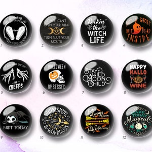 May include: A set of twelve circular black buttons featuring various white and orange graphic designs with text including phrases like Rockin' the Witch Life, Halloween Obsessed, Stay Wild Moon Child, and Make Today Magical, arranged in a grid.