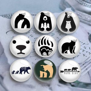 May include: Nine round glass magnets featuring bear designs. The designs include a bear with a cub, a bear with trees, a polar bear face, bear paw prints, a bear silhouette, and a bear family with the text "MAMA BEAR".