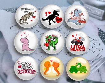 May include: Nine round, glass-like magnets with dinosaur designs. The magnets feature various dinosaurs with text like "Lovasaurus Rex", "Roar", "Rawr You", "Heart Breaker", "I Steal Hearts", and "Love Bites". Each magnet has a white background with red hearts.