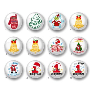 May include: A set of twelve circular white buttons featuring various Christmas-themed graphics, including a red oven mitt, a green character, yellow bells, Santa Claus, and text such as Holiday Baking Team, Merry Christmas, and My First Christmas.