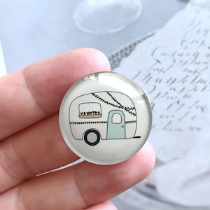 May include: A white and light blue camper van with a window and a door. The camper van has a string of lights hanging from the roof and a small flower box in the window. The camper van is on a white background.