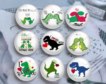 May include: Nine round glass magnets with dinosaur illustrations and phrases like "You Make My Heart Saur," "I Rawr You," and "Love Bites." The magnets feature green, red, and blue dinosaurs with hearts.