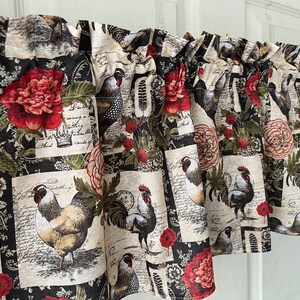 May include: A valance featuring a repeating pattern of roosters, red flowers, and botanical elements on a black and cream background. The fabric has a vintage, farmhouse aesthetic, suitable for kitchen or dining room decor.