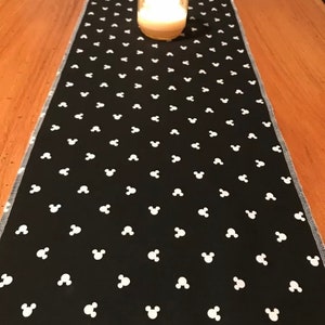 10”x42” runner made with mickey material. Black white mickey head table decor. Bedroom dresser nightstand decor. Hangover sides . Disney.