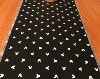 10”x42” runner made with mickey material. Black white mickey head table decor. Bedroom dresser nightstand decor. Hangover sides . Disney.