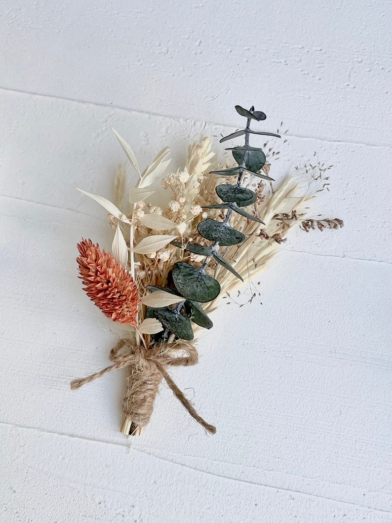 These mini bouquets feature a boho and unique mix of real dried flowers, making them perfect boutonnieres for rustic boho weddings
