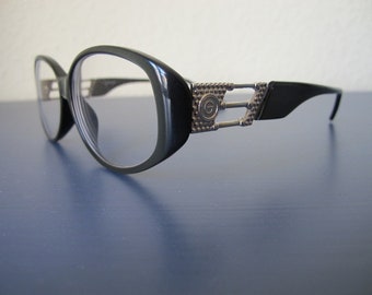ovale dunkelgrüne Acetatbrille mit Applikationen an den Bügeln