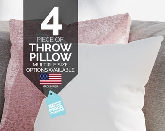 May include: Four white throw pillows on a couch with a pink and gray throw pillow behind them. The pillows are made in the USA and have a "Best Price Promise" tag.