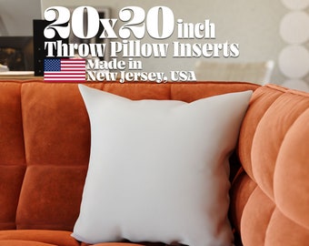 May include: A white 20x20 inch throw pillow insert on an orange couch. The text "20x20 inch Throw Pillow Inserts Made in New Jersey, USA" is above the pillow.