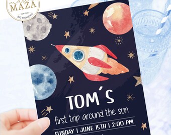 May include: A blue and black space-themed party invitation with a rocket ship, planets, and stars. The text reads "TOM'S first trip around the sun SUNDAY I JUNE 15TH | 2:00 PM Area 55 park Galaxy spaceship 9534, Houston, Texas."