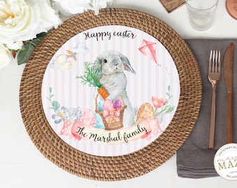 May include: A pink and white striped paper plate with a watercolor illustration of a bunny holding a basket of Easter eggs. The plate has the text "Happy Easter" and "The Marshal family" on it.