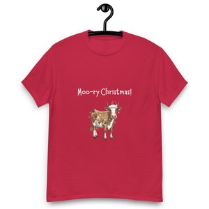 May include: Red t-shirt with a white cow wearing a Santa hat and Christmas lights. The text "Moo-ry Christmas!" is printed on the shirt.