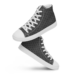 May include: A pair of high-top canvas shoes with a black and white geometric pattern. The shoes have white laces and a white sole.