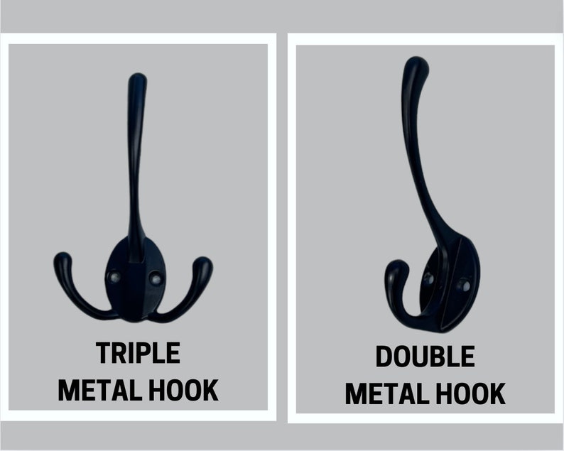 May include: A black metal triple hook with a central vertical prong and two side prongs, and a black metal double hook with one vertical prong and one side prong. Both hooks feature oval mounting plates with two visible screw holes for installation.