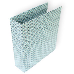 May include: A blue and white patterned binder with a repeating design of stylized fans.