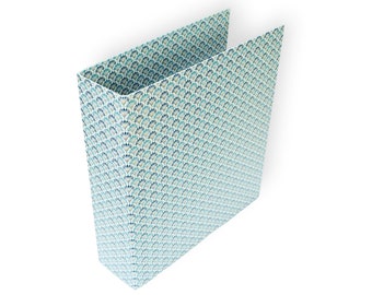 May include: A blue and white patterned binder with a repeating design of stylized fans.