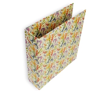 May include: An open, rectangular paper gift bag with a cream-colored background. The bag is decorated with a repeating pattern of colorful, ornate floral and leaf designs in shades of orange, yellow, purple, and blue.