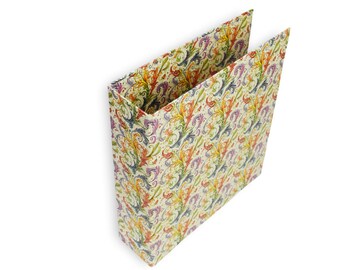 May include: An open, rectangular paper gift bag with a cream-colored background. The bag is decorated with a repeating pattern of colorful, ornate floral and leaf designs in shades of orange, yellow, purple, and blue.