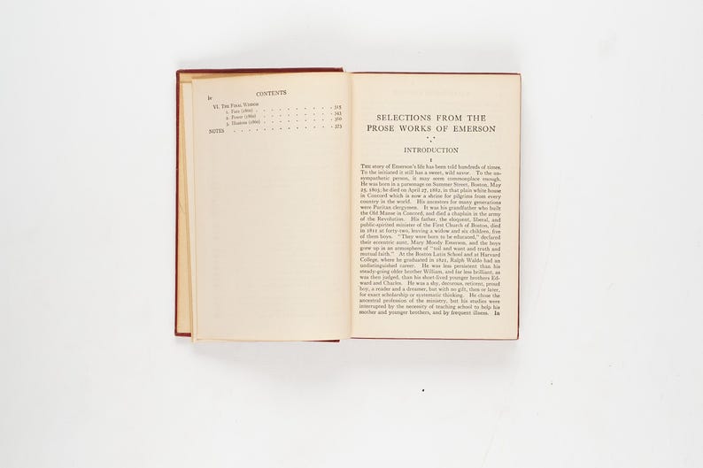 May include: An open book titled "Selections from the Prose Works of Emerson" with a red cover. The left page displays the table of contents, while the right page shows the introduction. The pages are cream-colored.