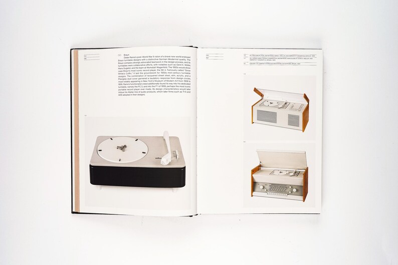 May include: A page from a design book featuring a vintage turntable with a white dial and a black base. A white tone arm rests on the turntable. The book also shows two vintage stereo systems with wooden accents.
