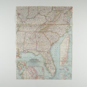 May include: A vintage map of the Southeastern United States, including Florida, Georgia, and the Gulf of Mexico. The map features detailed road networks, cities, and geographical features, with text that reads "Gulf of Mexico" and "United States."