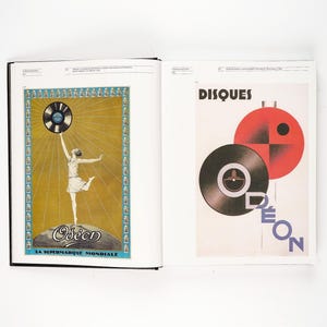 May include: Two-page spread from a book featuring vintage advertisements. One page shows a woman holding a record above her head, with the text "Odeon" and "LA SUPERMARQUE MONDIALE". The other page displays the word "DISQUES" and a graphic of records.