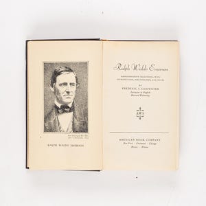 May include: An open book featuring a portrait of Ralph Waldo Emerson on the left page and the title page of a book on the right. The title page reads "Ralph Waldo Emerson" and includes the author's name, Frederic I. Carpenter, and the American Book Company logo.