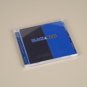 May include: A CD case with the album title "BLACK & BLUE" in blue text. The cover is split vertically, with a black and blue section. The spine reads "BACKSTREET BOY" in blue.