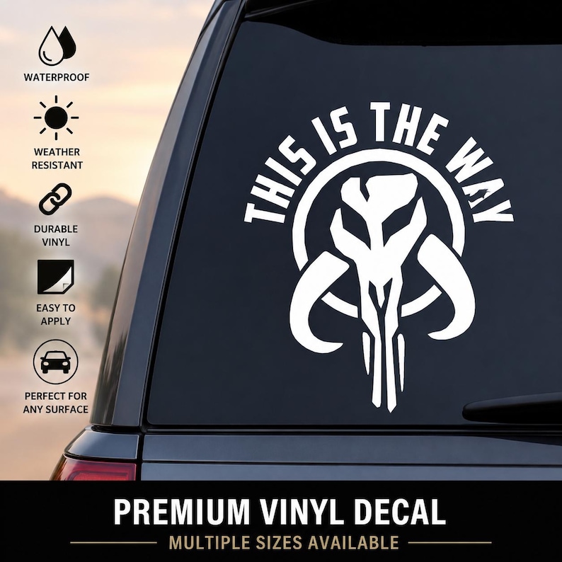May include: A white vinyl decal applied to a car window featuring a stylized Mandalorian mythosaur skull icon centered within a circular border, with the text THIS IS THE WAY arched in bold capital letters above the graphic design.
