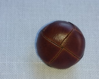 Leather button. Available in two sizes.