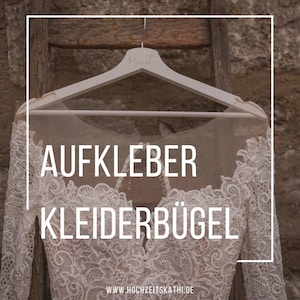 Könnte beinhalten: Ein weißer Holz Kleiderbügel mit dem Wort "Braut" darauf. Der Bügel trägt ein weißes Spitzen Brautkleid. Der Text "AUFKLEBER KLEIDERBÜGEL" ist in schwarzen Buchstaben auf dem Bild geschrieben. Der Text "WWW.HOCHZEITSKATHI.DE" ist in schwarzen Buchstaben am unteren Rand des Bildes geschrieben.