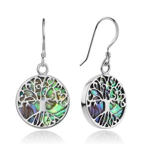 May include: Sterling silver earrings featuring a tree of life design with abalone shell inlay. The earrings are circular in shape and dangle from a hook.