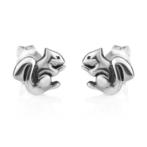 May include: A pair of silver squirrel stud earrings. The squirrels are facing forward with their tails curled behind them.