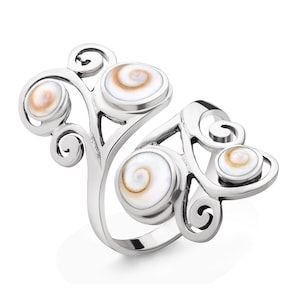 Puede incluir: Anillo de plata con un diseño de espiral y tres incrustaciones redondas de concha blanca y marrón.