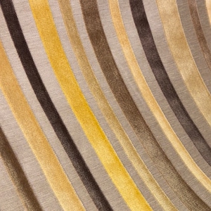 Gold, brown, yellow raised velvet stripe upholstery fabric on gray silky woven fabric