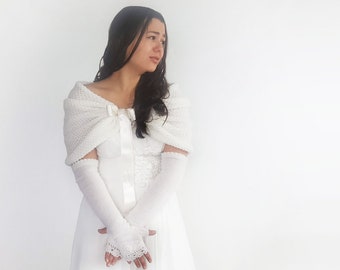 May include: White knitted gloves and a matching shawl with a satin ribbon. The gloves have a delicate lace trim.