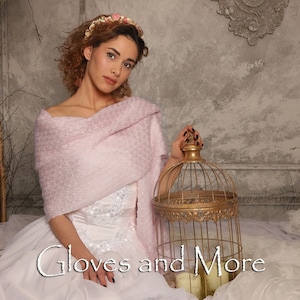 May include: A woman wearing a pink knitted shawl and a white dress with floral embroidery, holding a gold birdcage. The text "Gloves and More" is written in white on a white background.