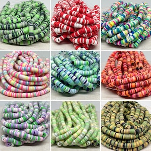 May include: Assortment of colorful striped polymer clay beads. The beads are arranged in rows, showcasing various color combinations, including green, red, blue, pink, yellow, and orange.